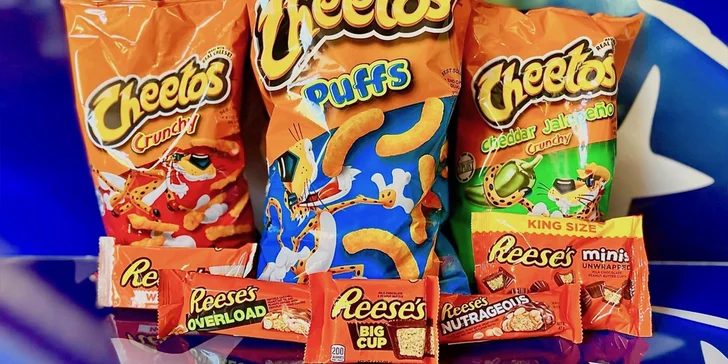 Balíčky amerických dobrot: kukuřičné křupky Cheetos a tyčinky Reese's v různých příchutích