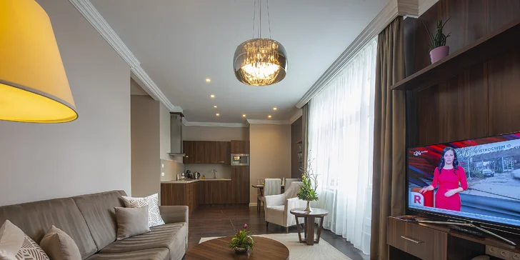 Součástí apartmánu je i obývací pokoj s rozložitelnou pohovkou. A o zábavu se postará velkoplošná televize.