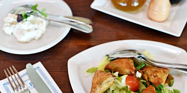 Tradiční řecké menu s předkrmem, mísou plnou masa, tzatziki a dezertem