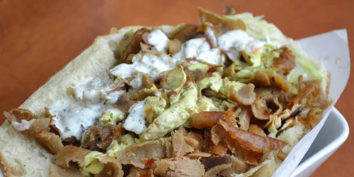 Tradiční gyros v pita chlebu nebo tortille s nápojem v restauraci Riva