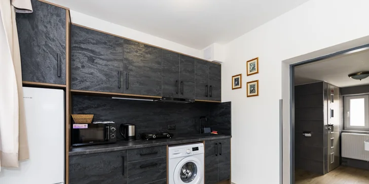 V kuchynke nájdete rýchlovarnú kanvicu, chladničku, mikrovlnku aj základné vybavenie a riad.