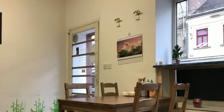 V malém bistru jsou dva stoly k sezení. 