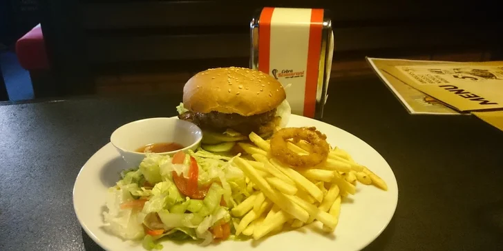 Váš americký sen? 200gramový burger a porce hranolků, cibulové kroužky i zeleninový salát a omáčka.