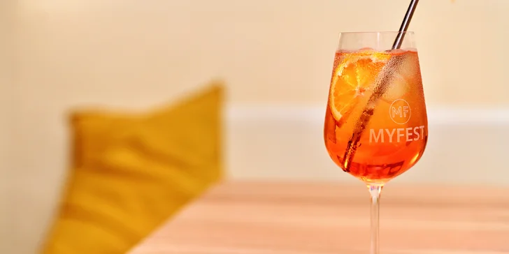 Připraví tu pro vás nápoj podle výběru. V nabídce je Aperol Spritz, Negroni Spritz, víno a pivo Bernard.