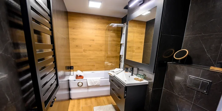 Kúpeľňa v apartmáne Deluxe Suite s vírivou vaňou a WC.